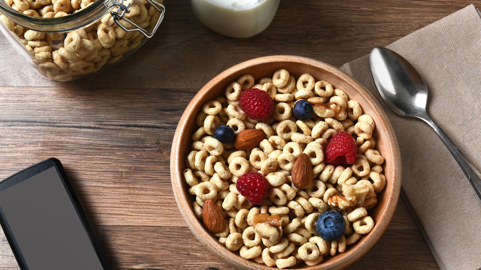 Bowl of cereal with berries and nuts showing a healthy breakfast mix