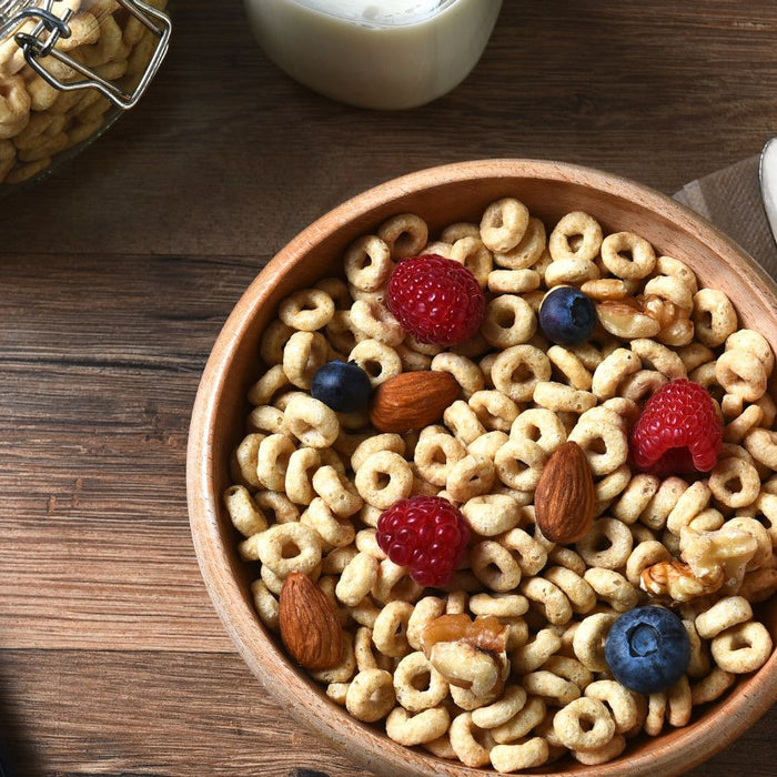 Bowl of cereal with berries and nuts showing a healthy breakfast mix