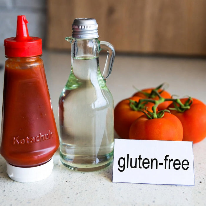 Ketchup, vinegar, tomatoes, and gluten-free label on counter