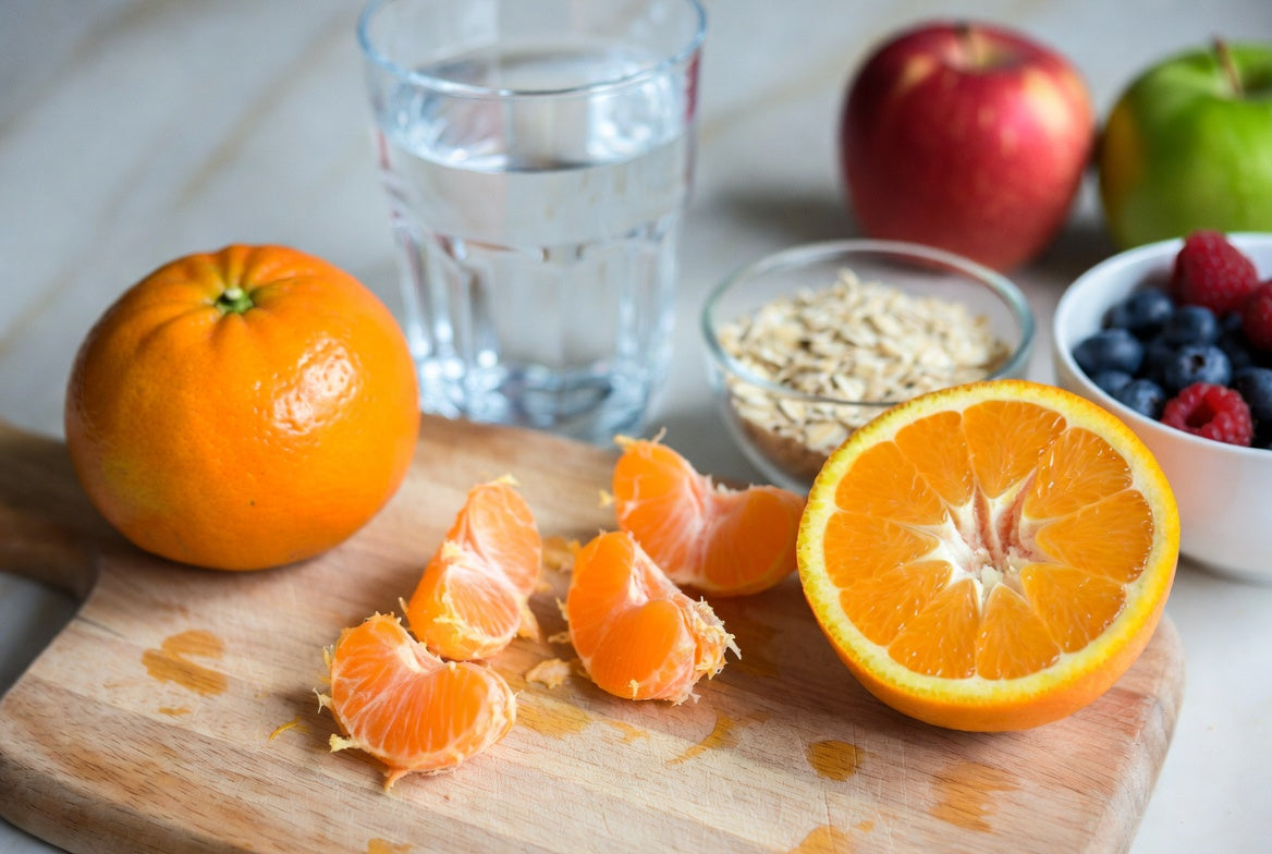 Fresh orange slices and whole oranges with oats and berries on board