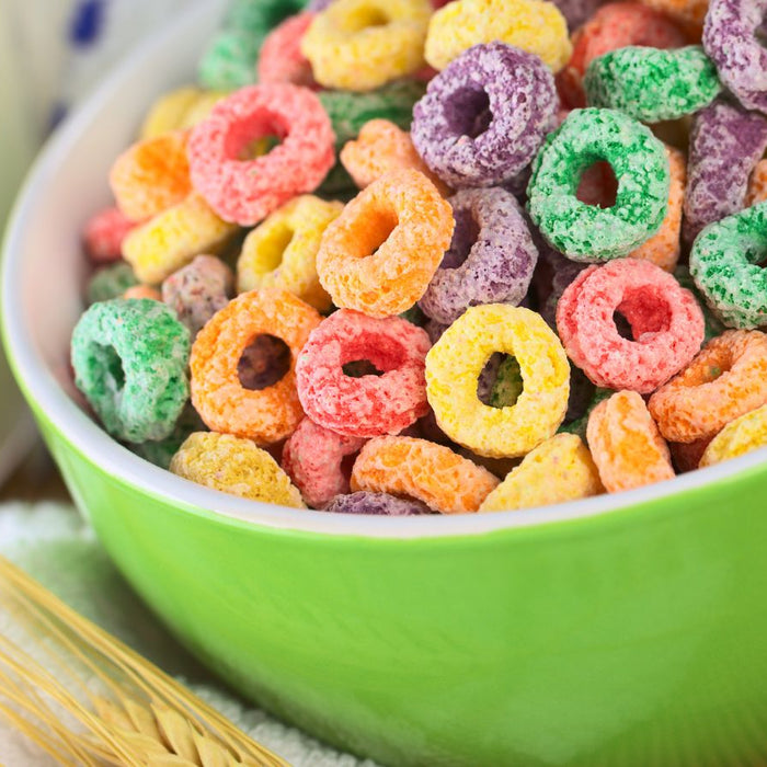 Green bowl filled with colorful fruit-flavored breakfast cereal loops