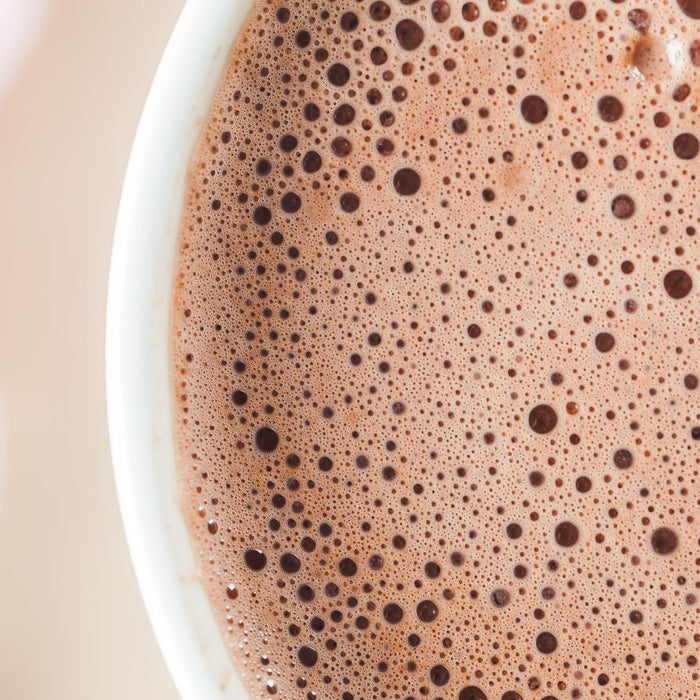 Close-up of frothy hot chocolate with tiny bubbles on the surface