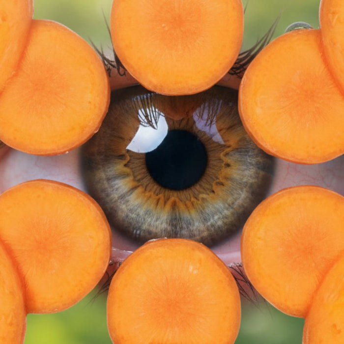 Close-up of human eye framed by overlapping carrot slices