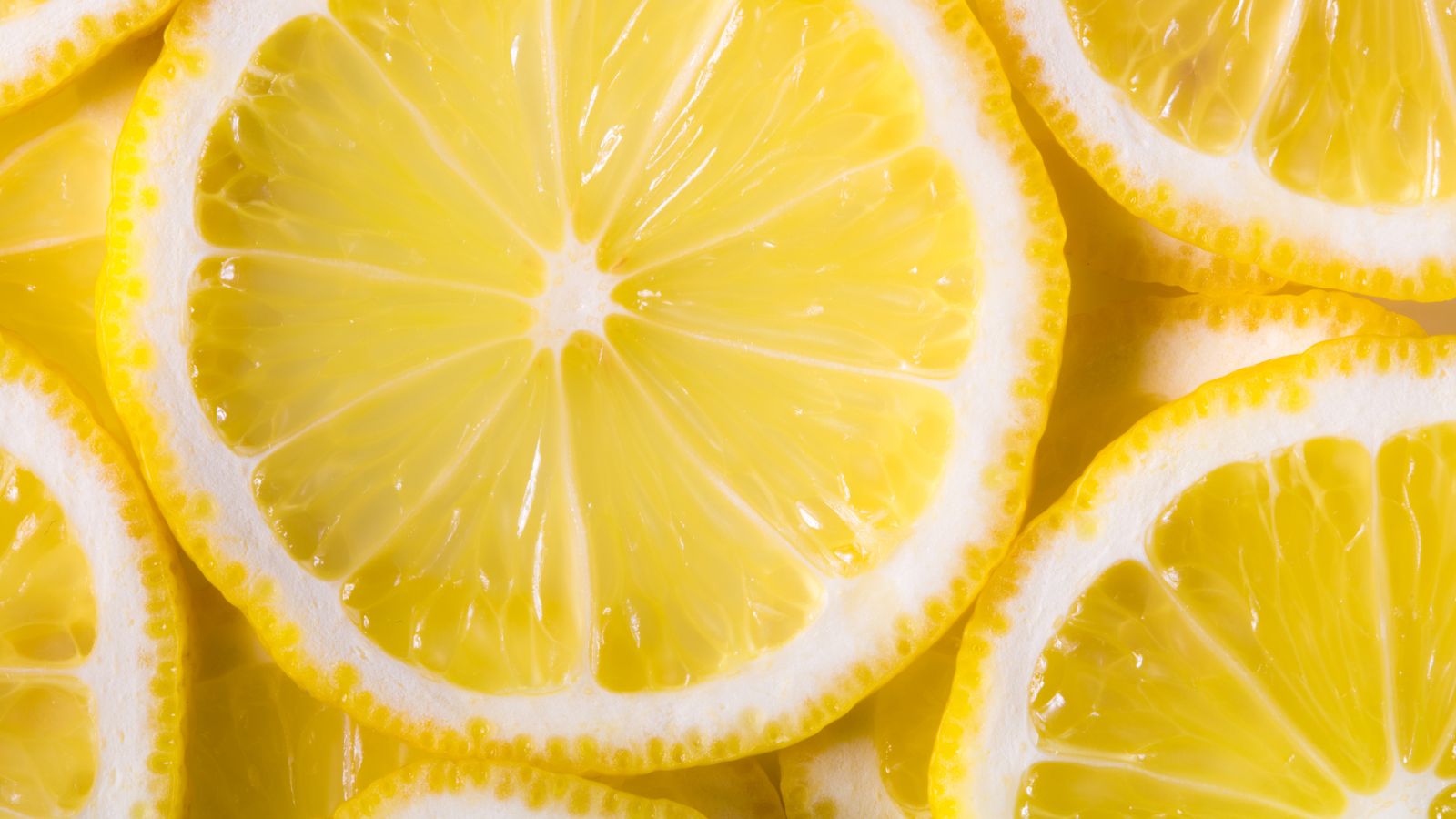 Close-up of fresh lemon slices showing bright yellow texture