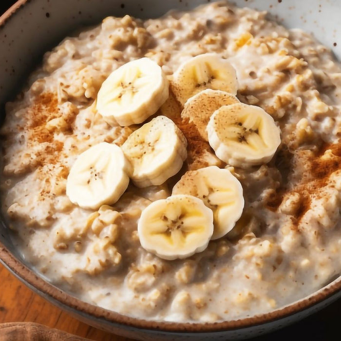 Oatmeal with banana slices and cinnamon in a ceramic bowl.