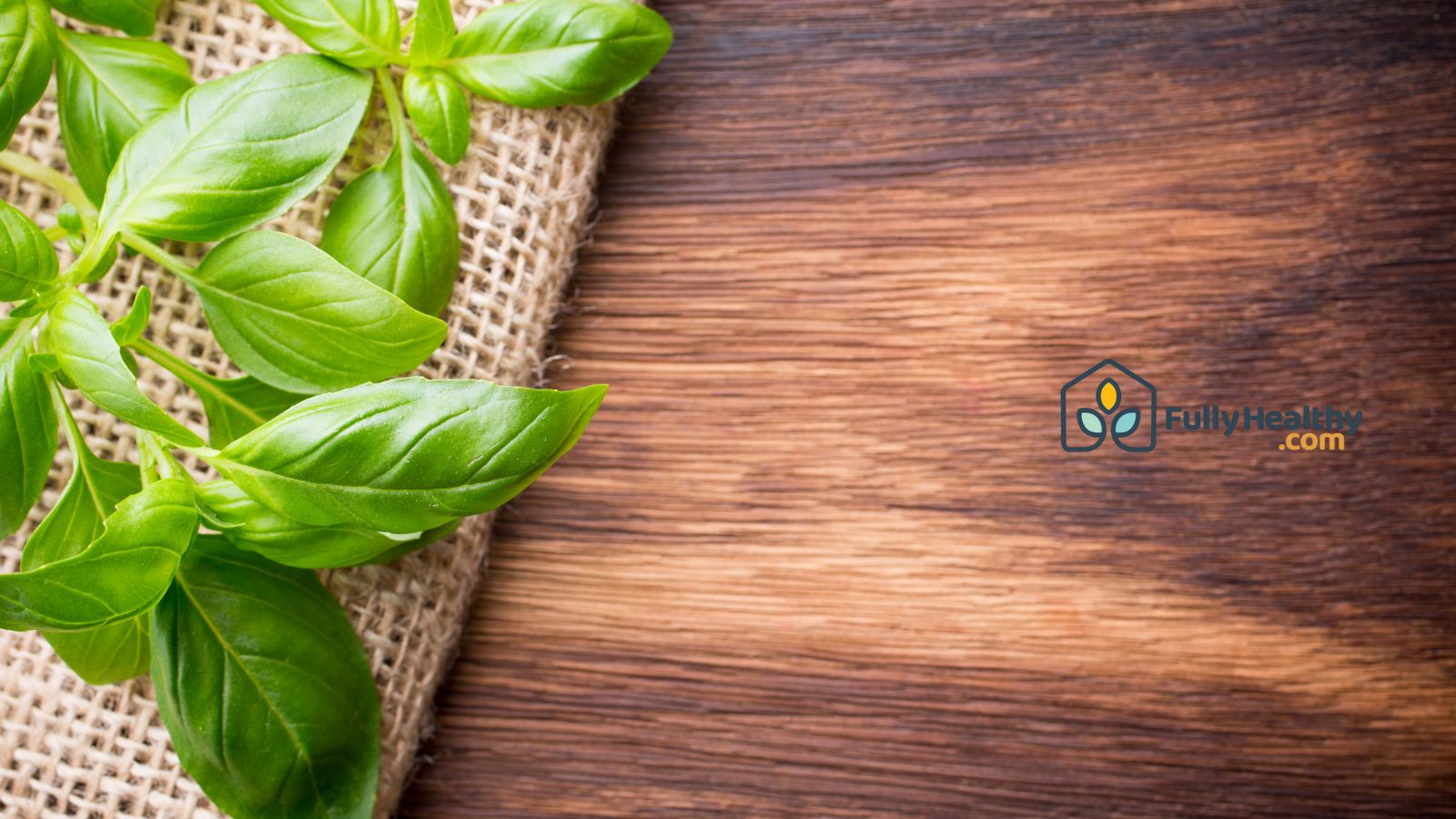 Fresh basil leaves on wooden surface for natural healthy cooking