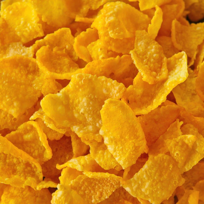 Close-up view of golden cornflakes breakfast cereal piled together