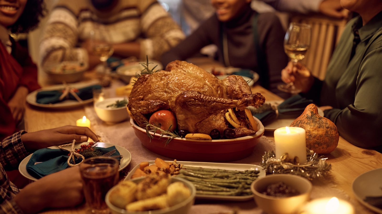 Family sharing a cozy dinner with a golden roasted turkey centerpiece
