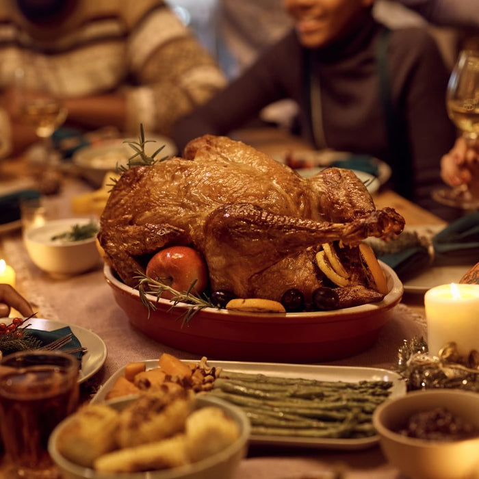 Family sharing a cozy dinner with a golden roasted turkey centerpiece