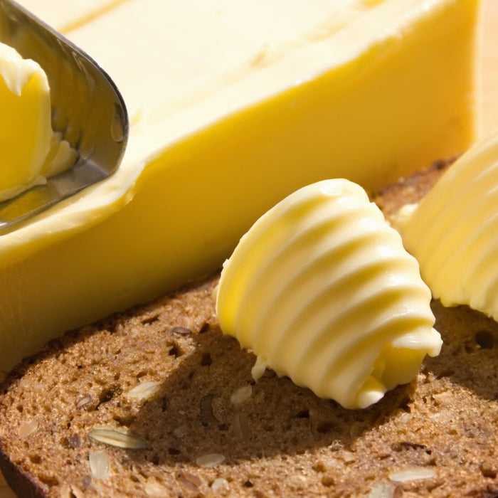 Butter curls on whole grain bread with a butter slicer.