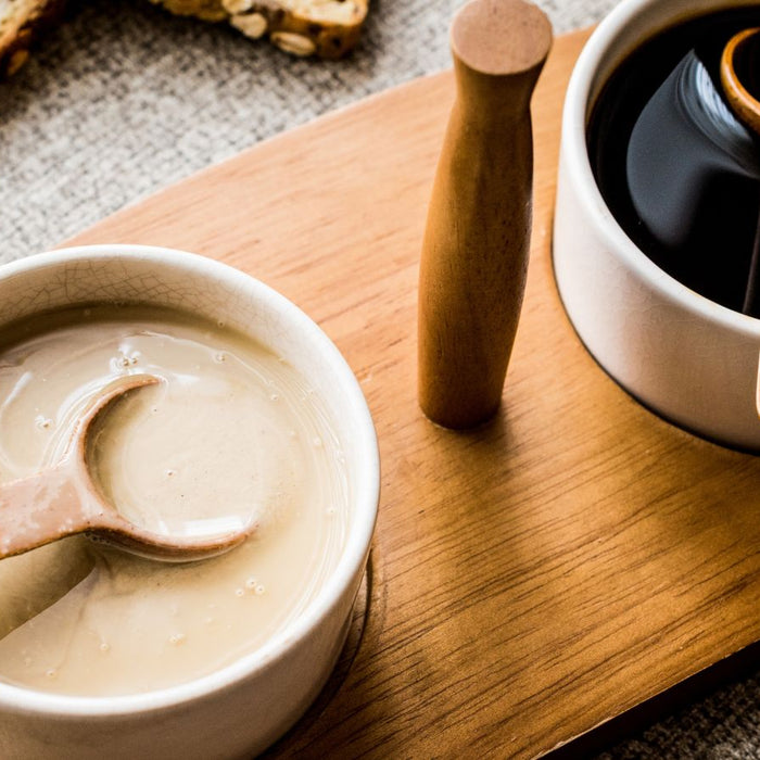 Creamy tahini and blackstrap molasses in white ceramic bowls.