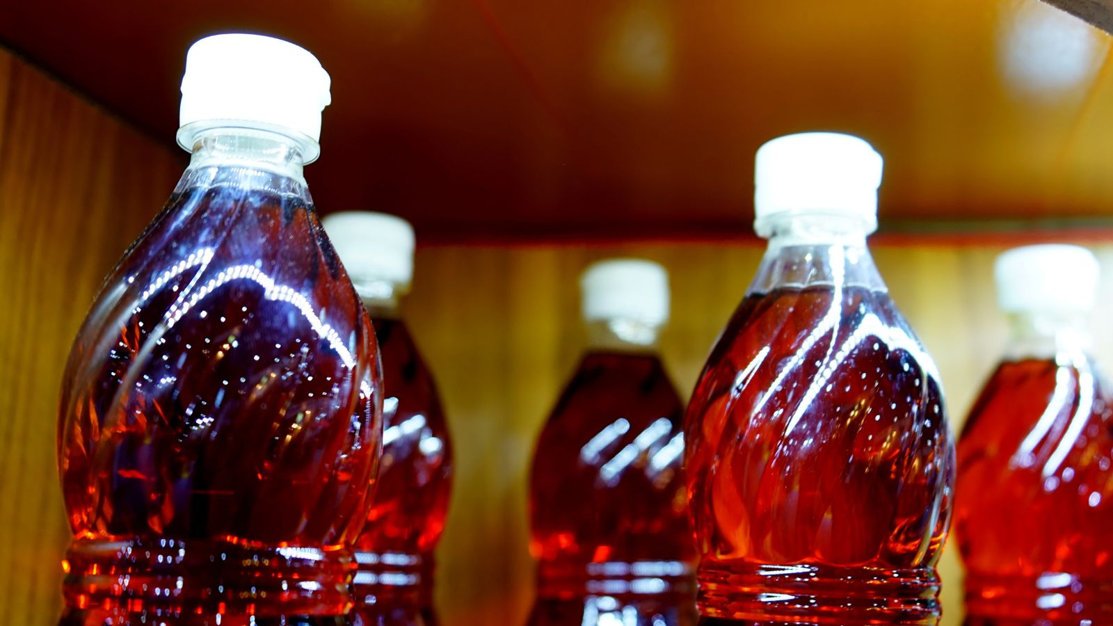 Bottles filled with fish sauce on a store shelf.