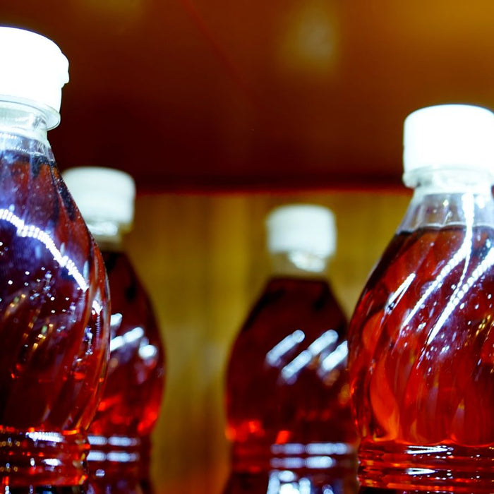 Bottles filled with fish sauce on a store shelf.