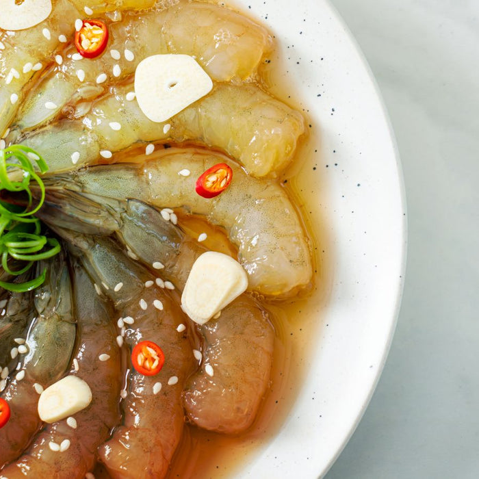 Raw marinated shrimp with garlic slices and chili in fish sauce marinade