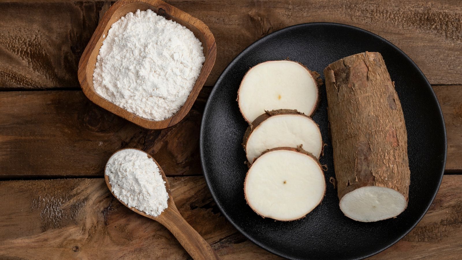 Image 3: Sliced cassava root with tapioca flour in bowl and wooden spoon.