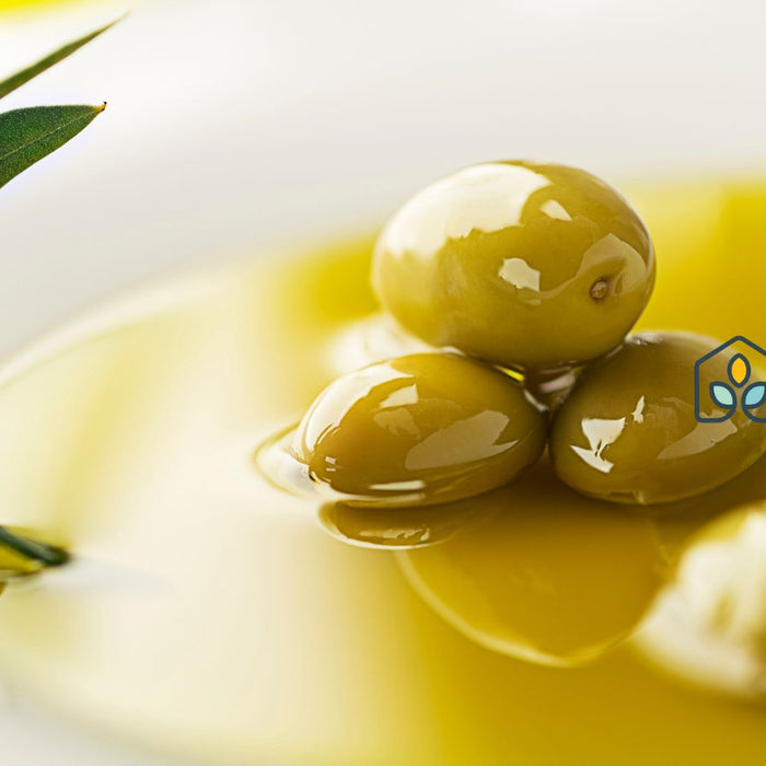 Close-up of green olives in olive oil for healthy Mediterranean diet.
