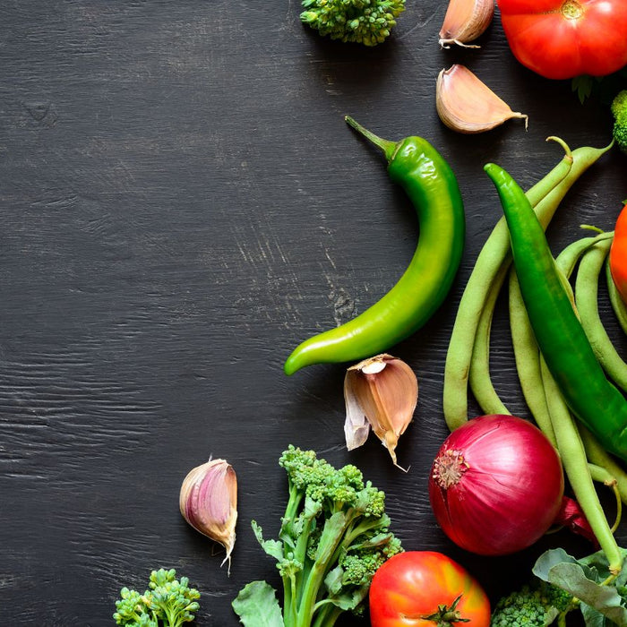 Fresh vegetables including chili, broccoli, tomatoes, and garlic, portraying all purpose seasoning.