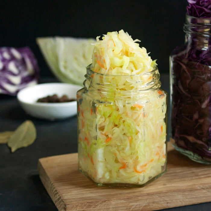 Jars of homemade sauerkraut with red and green cabbage.