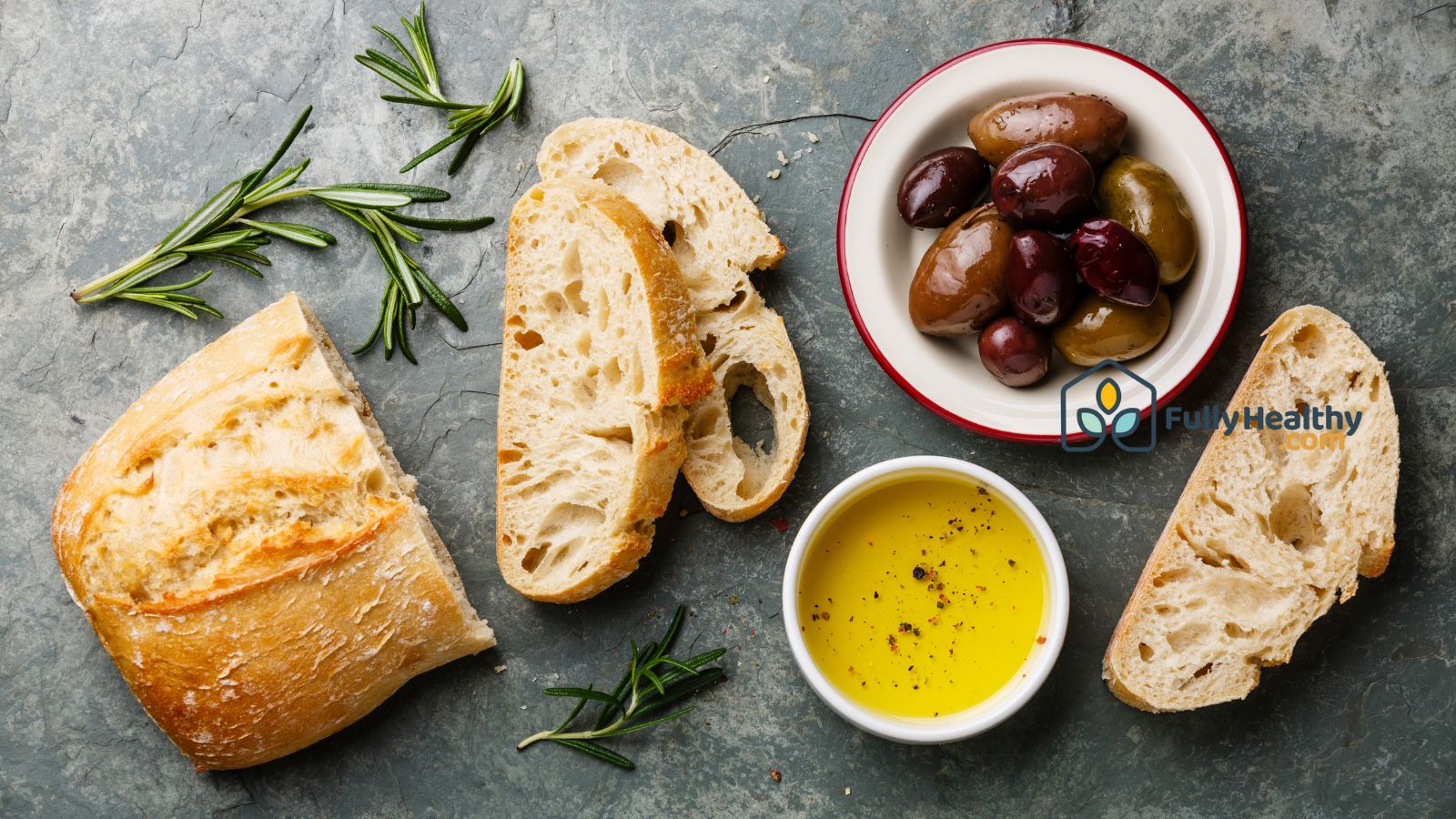 Bread with olive oil and olives on table for healthy Mediterranean meal.