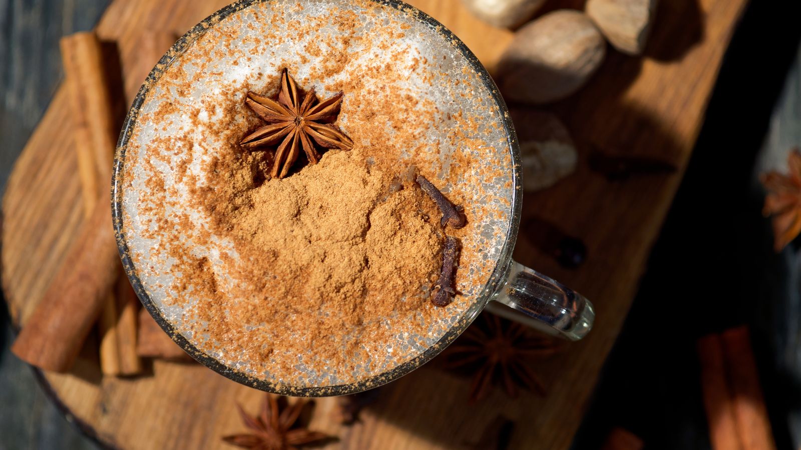 Top view of spiced chai latte with star anise and cinnamon