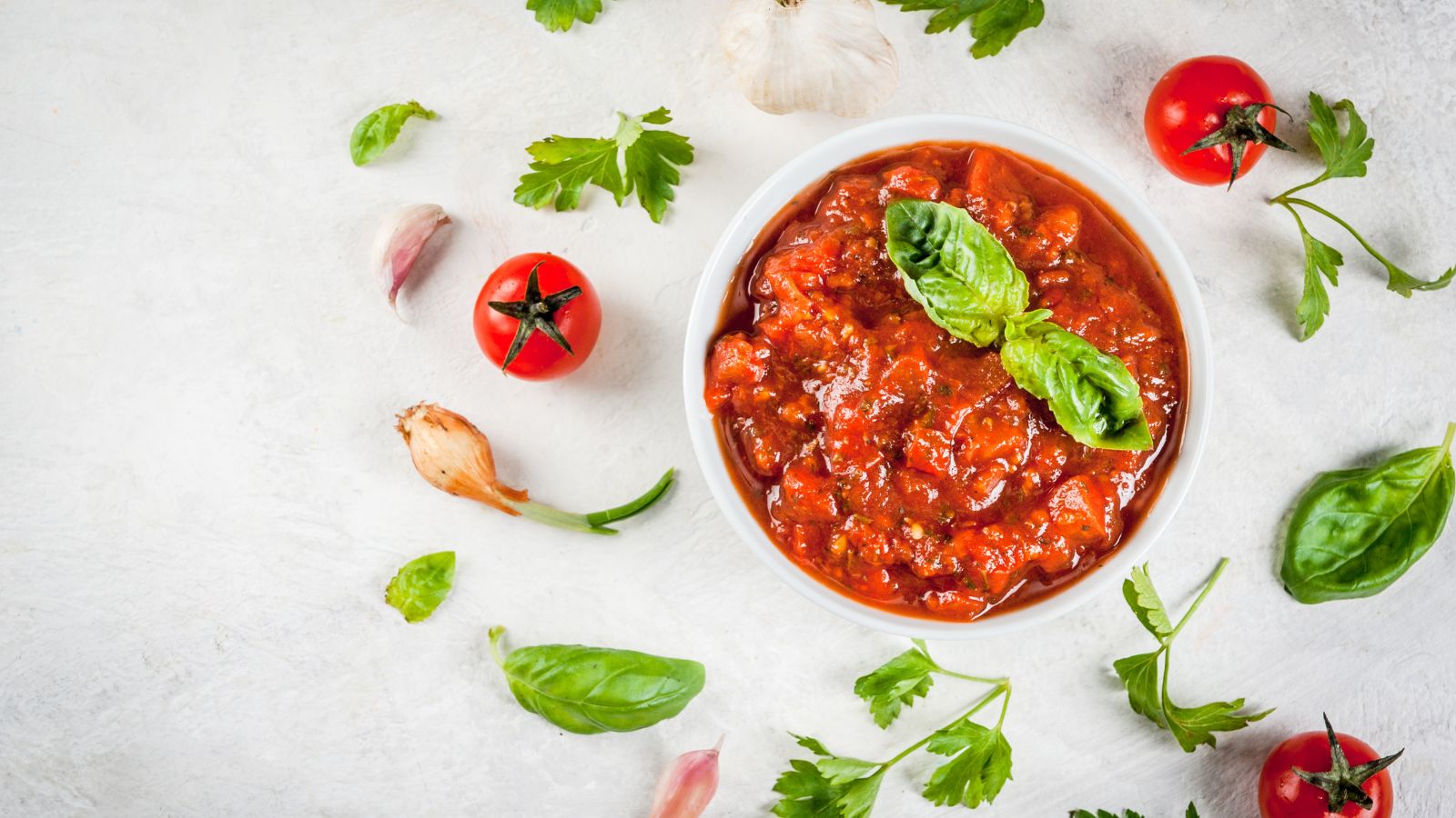 Fresh marinara sauce in bowl with garlic and parsley