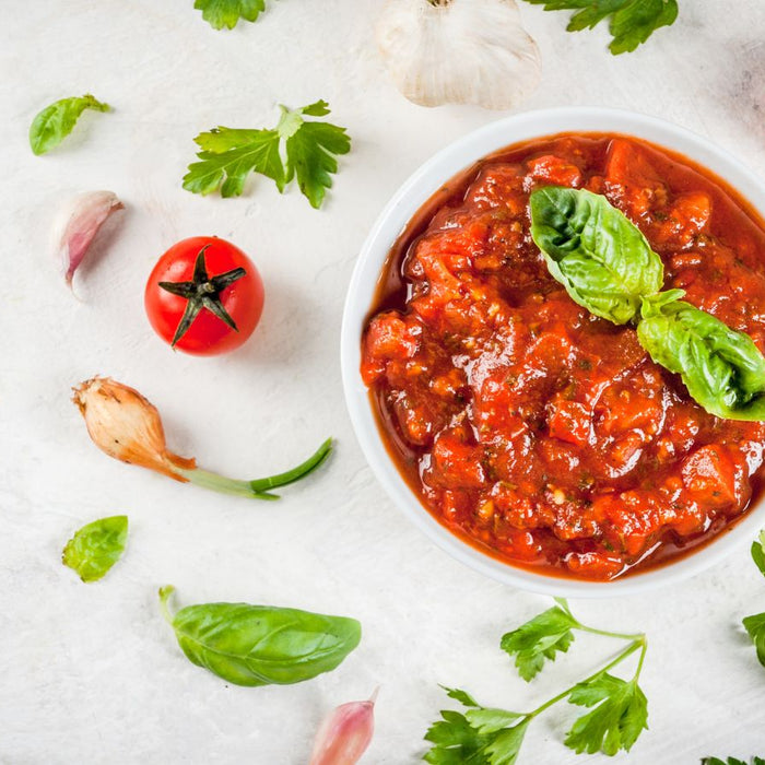 Fresh marinara sauce in bowl with garlic and parsley
