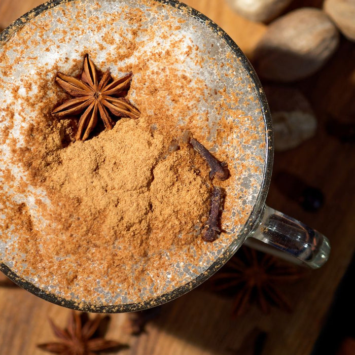 Top view of spiced chai latte with star anise and cinnamon