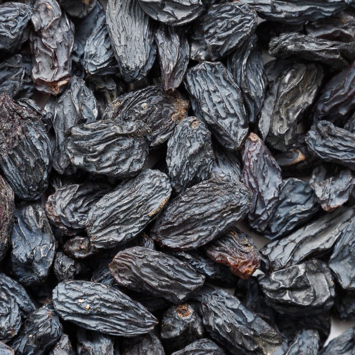 Dried black raisins closely packed together.
