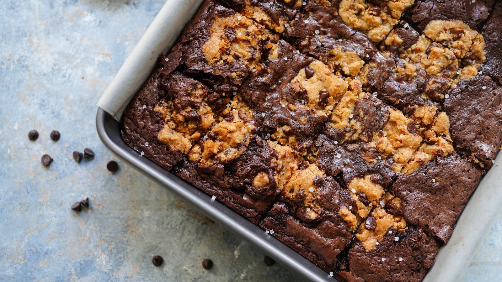 Peanut butter swirl fudge in a baking tray with chocolate chips