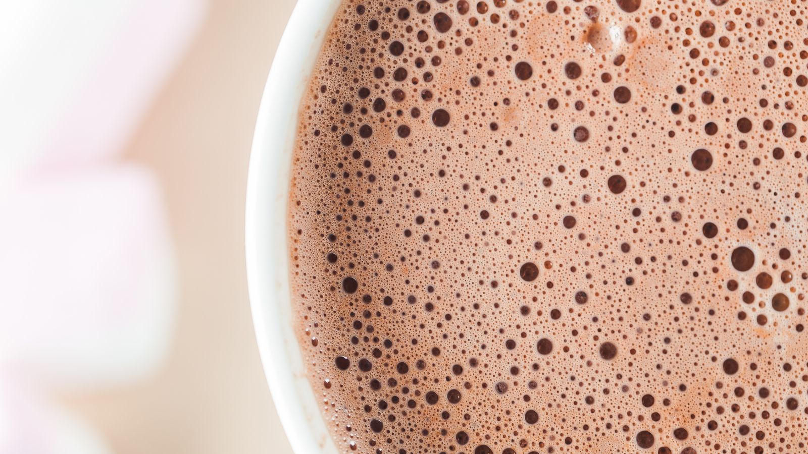 Close-up of frothy hot chocolate with tiny bubbles on the surface