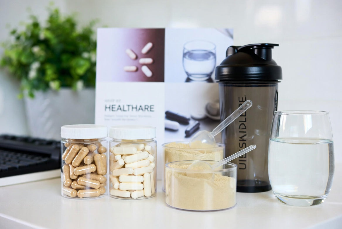 Peptide capsules, collagen powder, shaker bottle, and water on counter