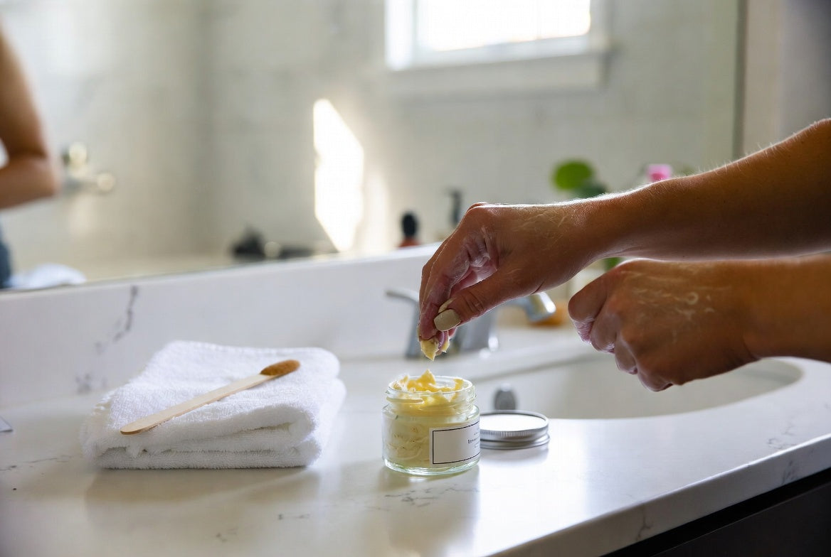 Beef tallow balm jar on bathroom counter beside folded white towel