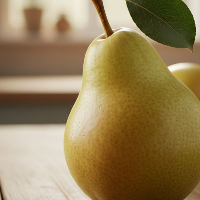 Ripe green pear with leaf resting on wooden table