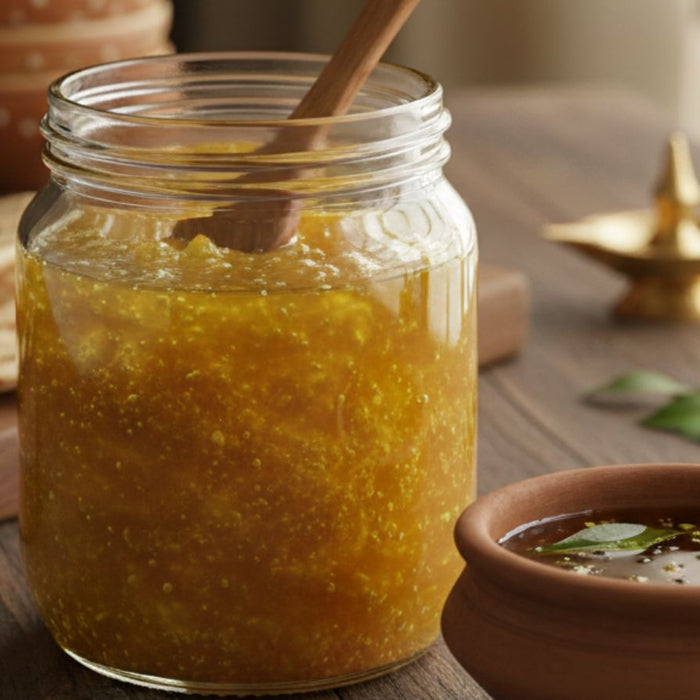 Jar of golden ghee beside traditional Indian meal