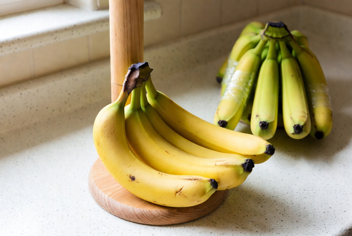 Bananas on a stand with stems wrapped to keep them fresh longer