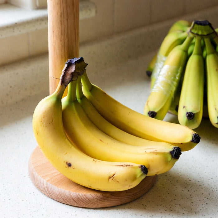 Bananas on a stand with stems wrapped to keep them fresh longer