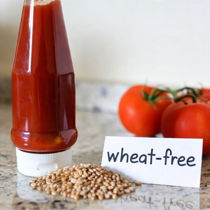 Ketchup bottle with wheat-free sign, wheat grains, and tomatoes