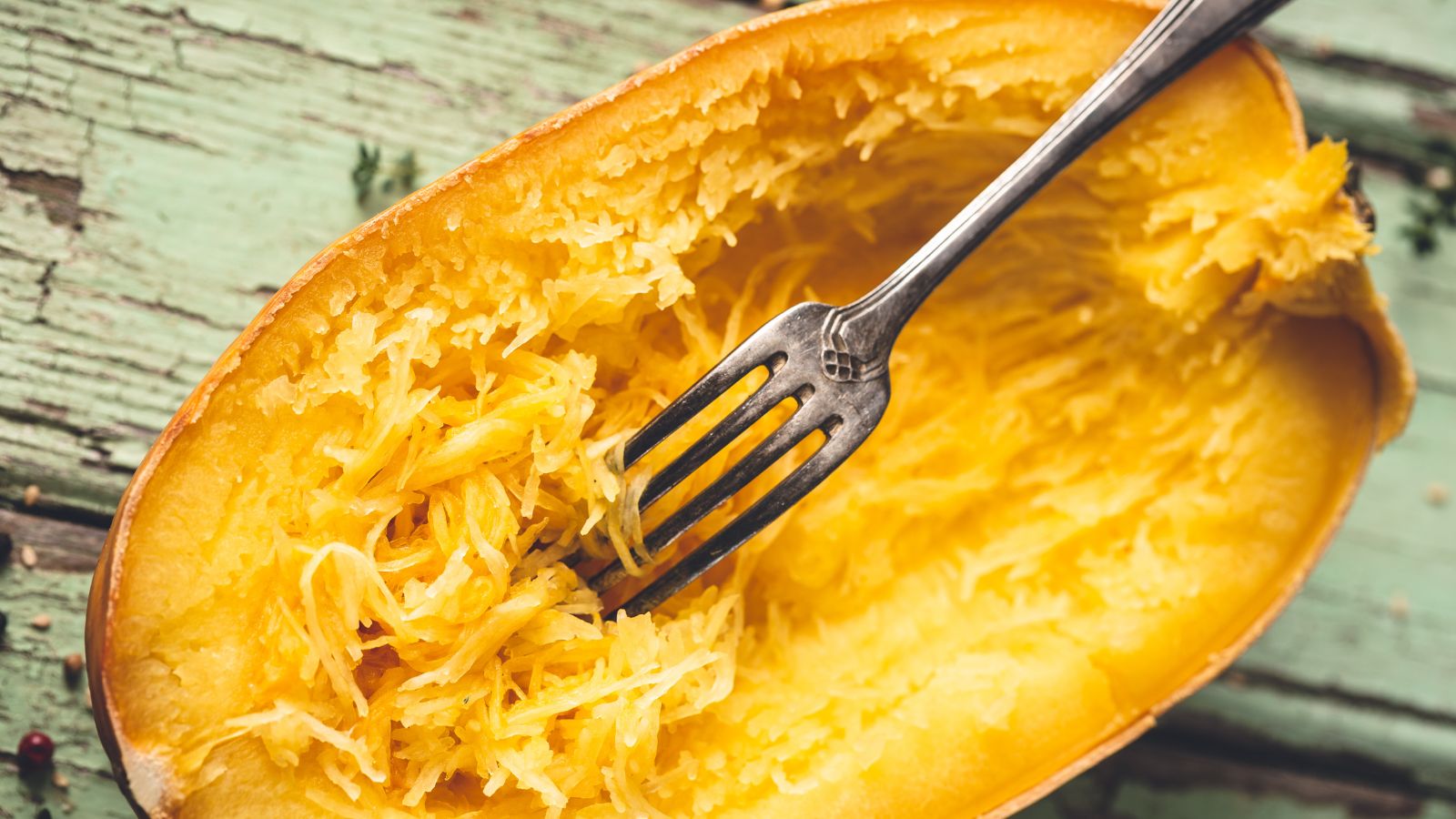 Baked spaghetti squash with fork pulling strands