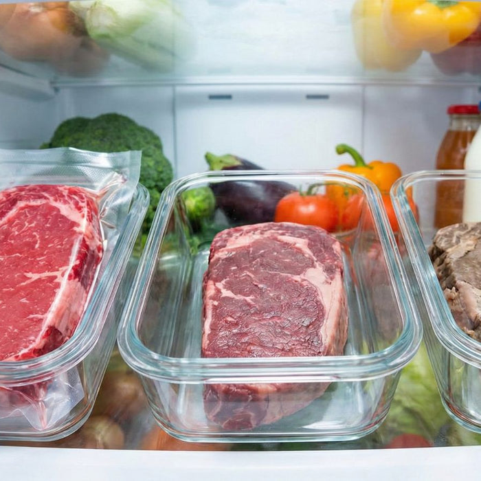 Raw and cooked beef cuts stored in glass containers in fridge