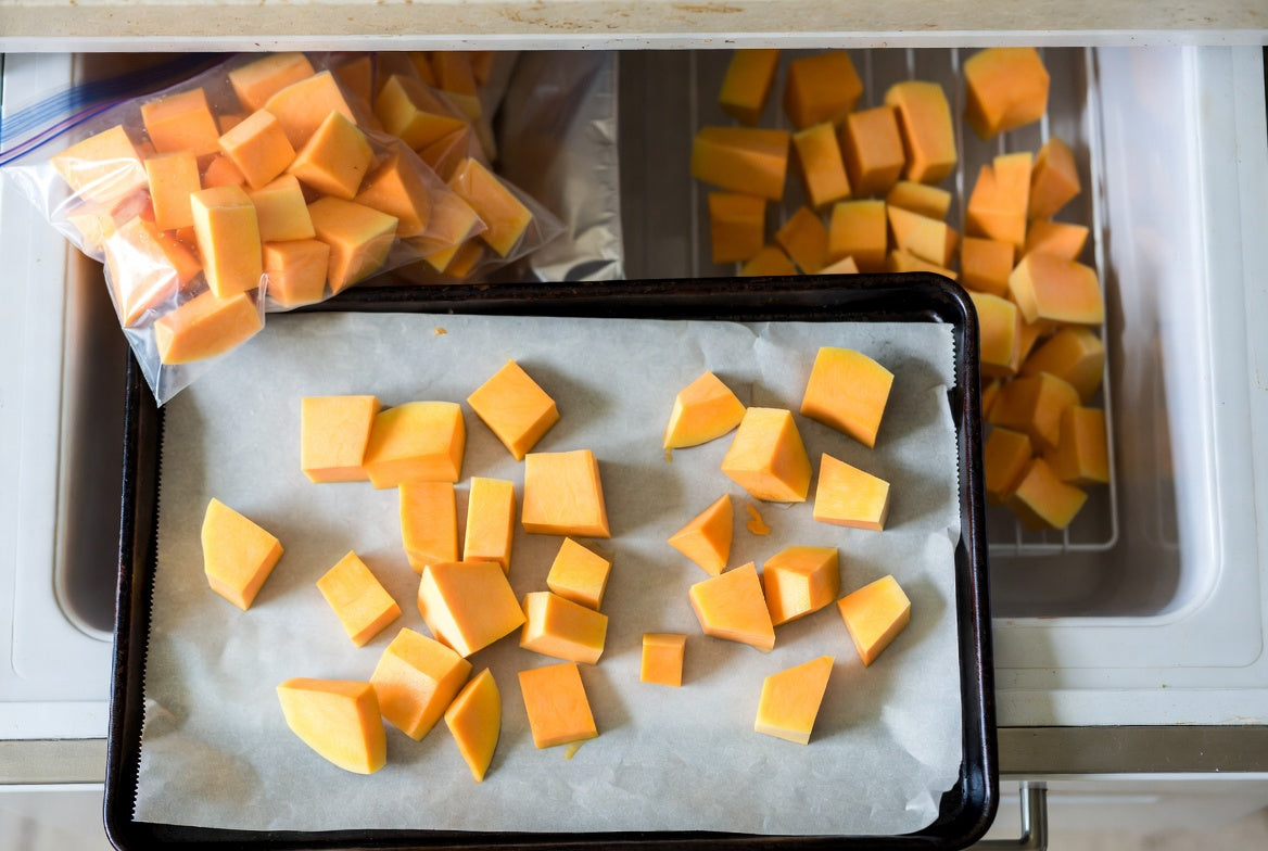 Cubed squash prepared on a tray for freezing