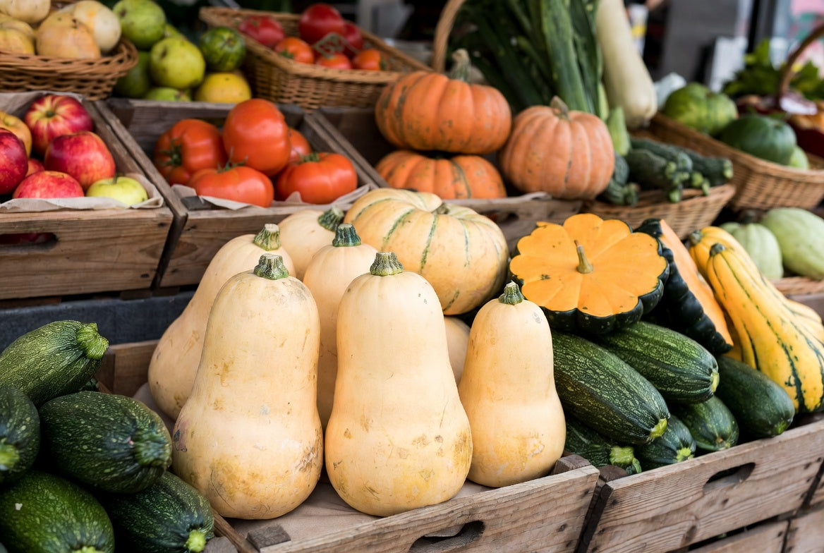Fresh squash varieties displayed in rustic market crates