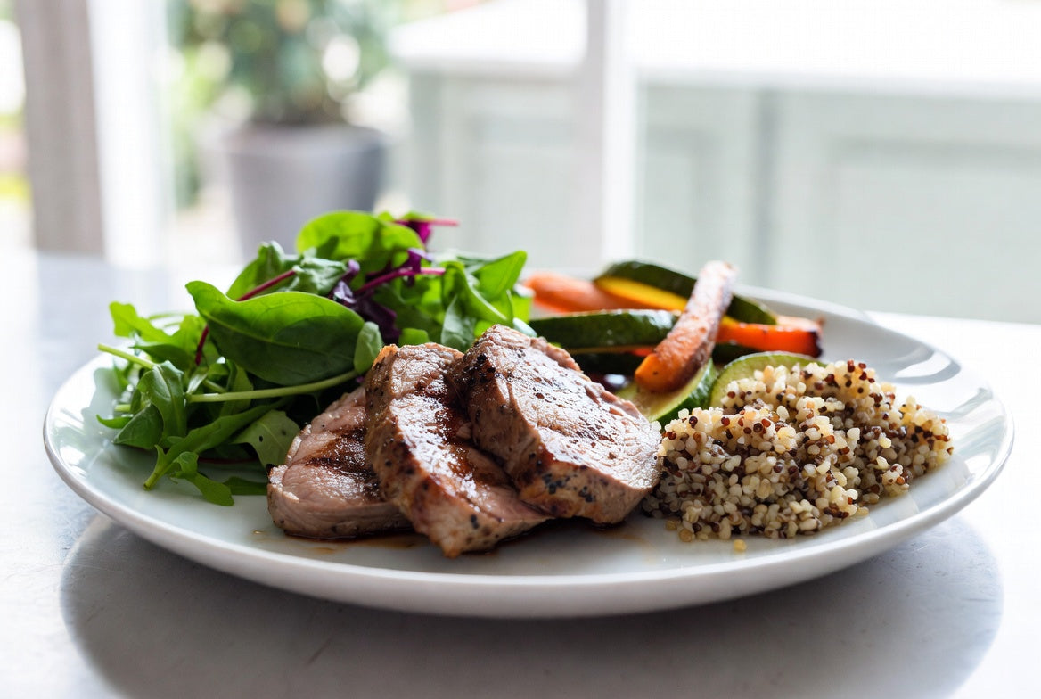 Healthy lamb meal with vegetables, grains and leafy green salad