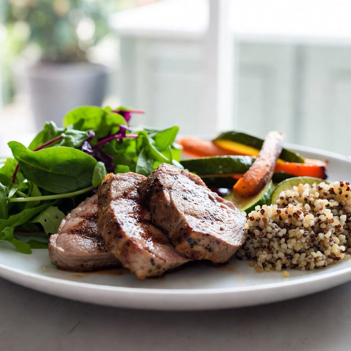 Healthy lamb meal with vegetables, grains and leafy green salad