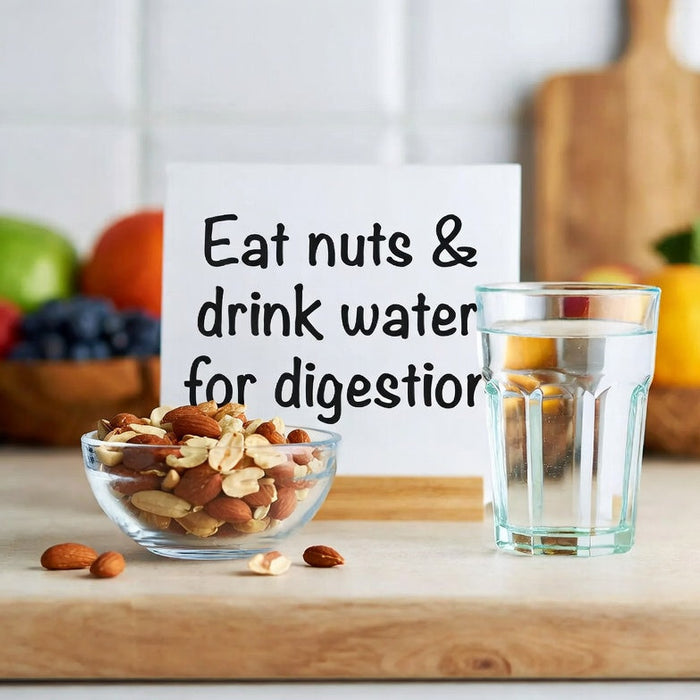 Bowl of mixed nuts and water glass with digestion sign in kitchen
