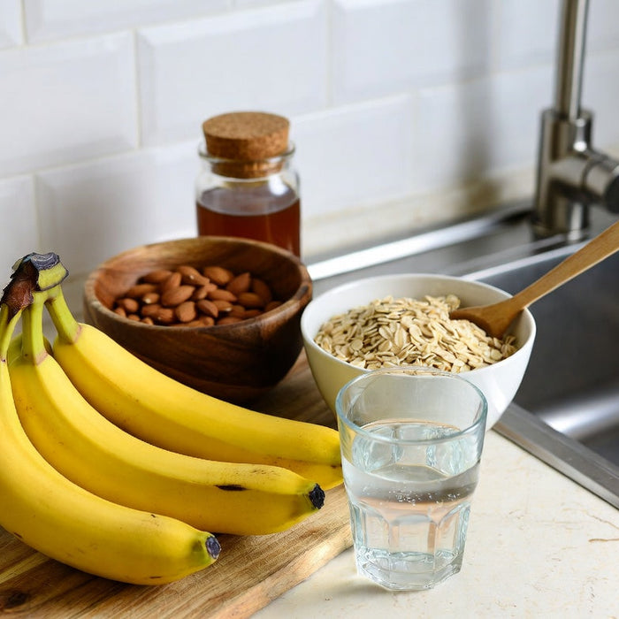 Bananas with oats, almonds, honey and water on a sunny countertop home