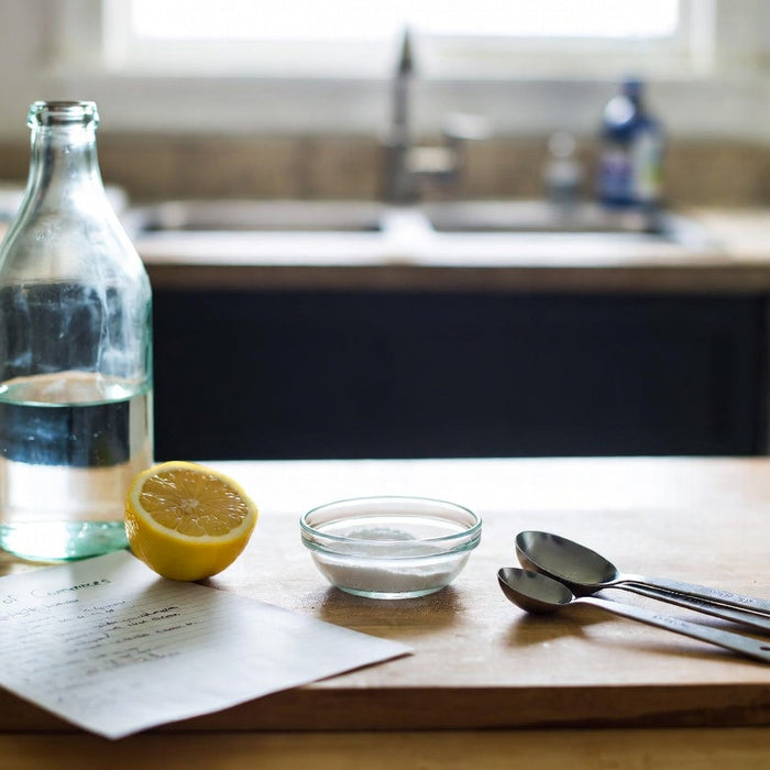 Vinegar, lemon, and baking soda arranged for a home acid test