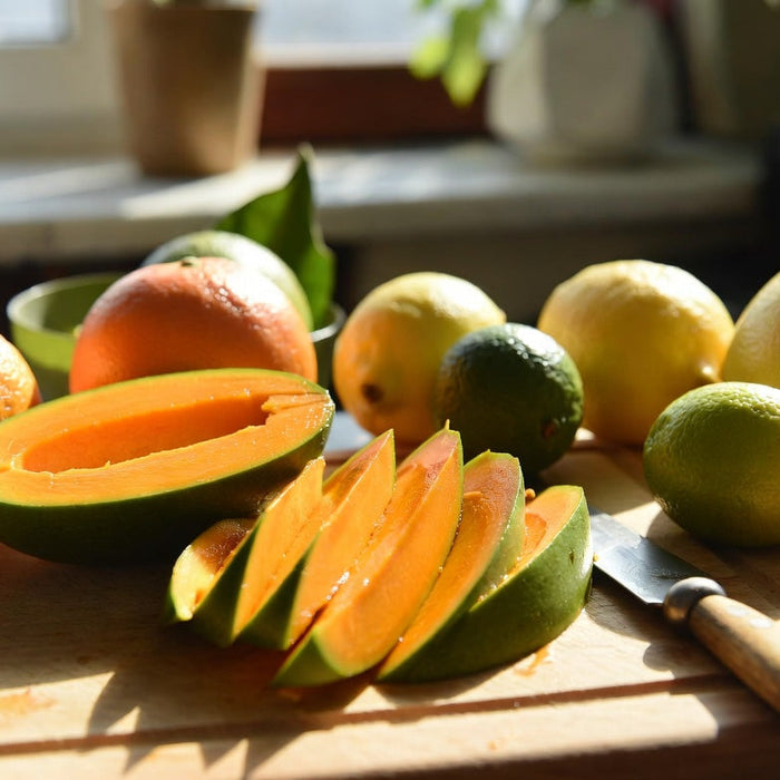 Sliced mango beside citrus fruits showing mango is not a citrus fruit