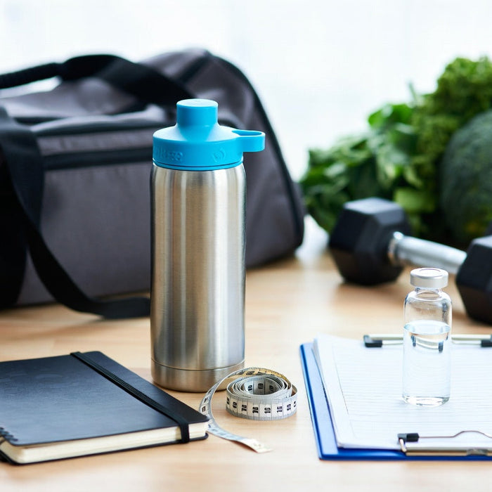 Peptides vial with fitness journal, water bottle, and gym equipment