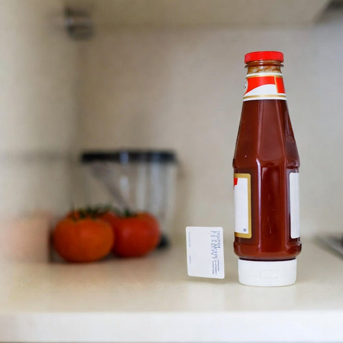 Ketchup bottle with date label on a bright kitchen counter