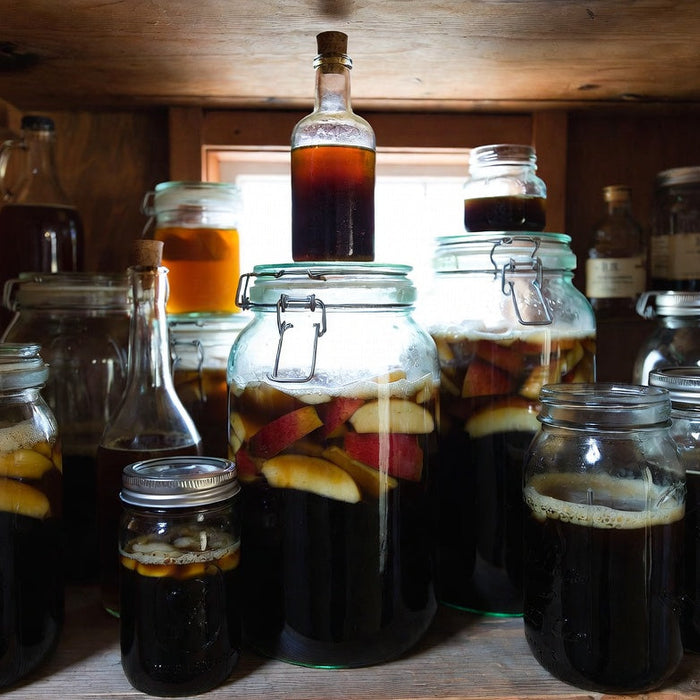 Pantry shelf filled with jars of fermenting homemade fruit vinegar